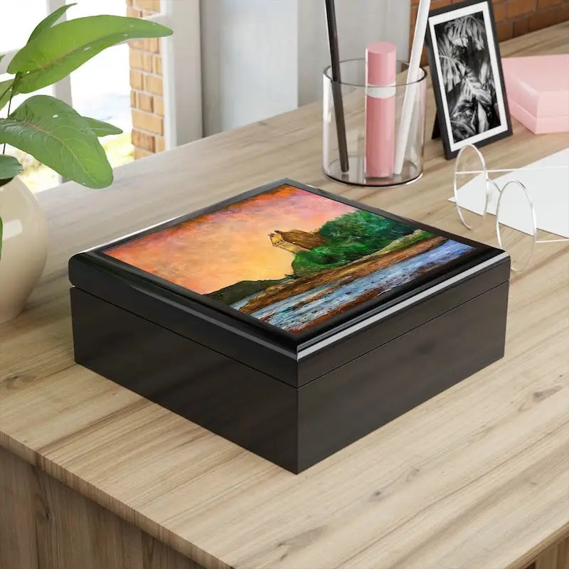 Black rectangular wooden keepsake box featuring a vibrant landscape painting on the lid