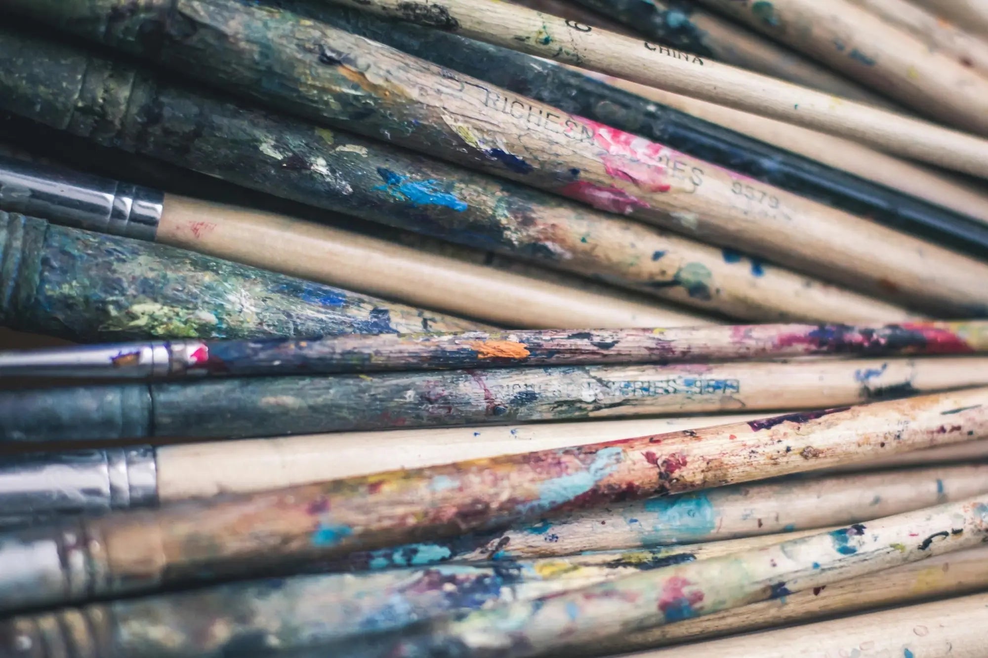 Pile of well-used paint-splattered artist brushes featured in Kevin Hunter article