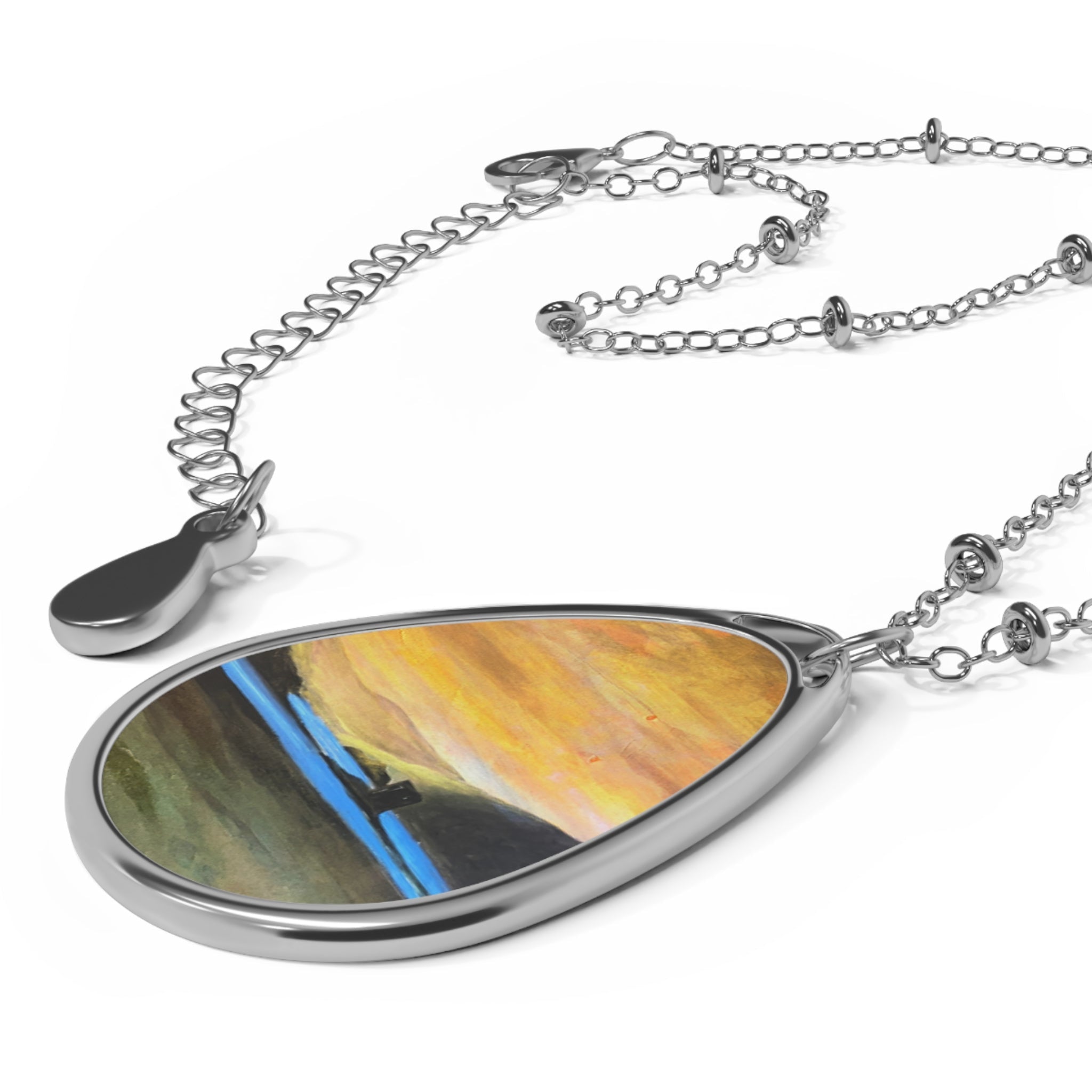 Castle Stalker Glow silver teardrop necklace with orange-yellow abstract art