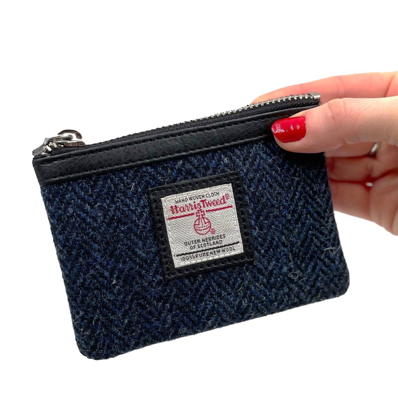 Navy blue Harris Tweed coin purse with zip closure black leather trim and branded label for secure coin storage