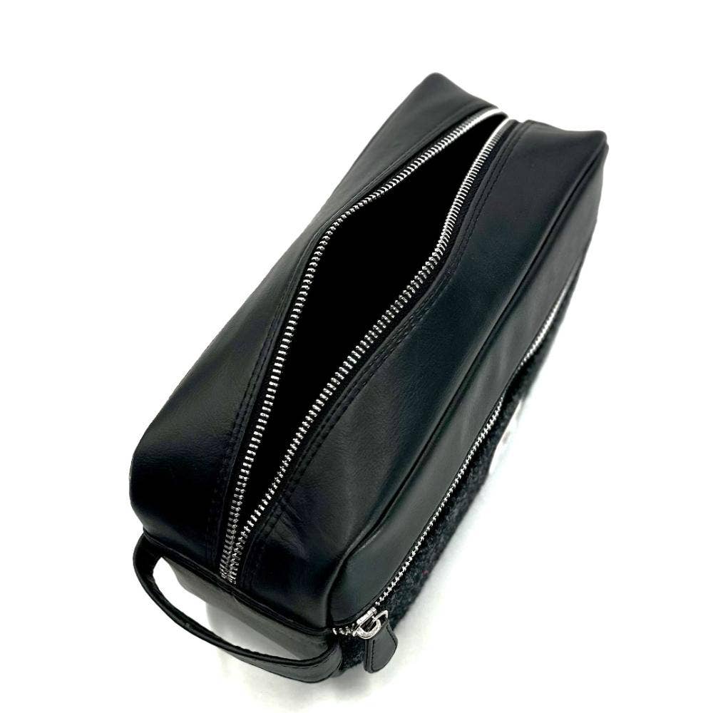 Black leather toiletry bag with silver zippers and sturdy handle from harris tweed charcoal collection