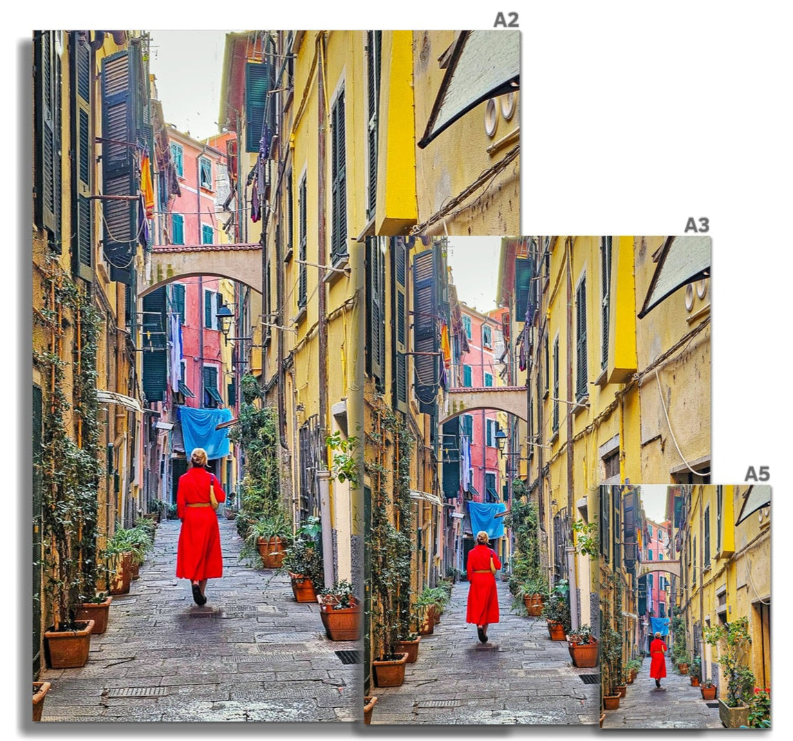 Backstreets of Lerici fine art print showing a person in a vibrant red robe walking down a colorful european alleyway
