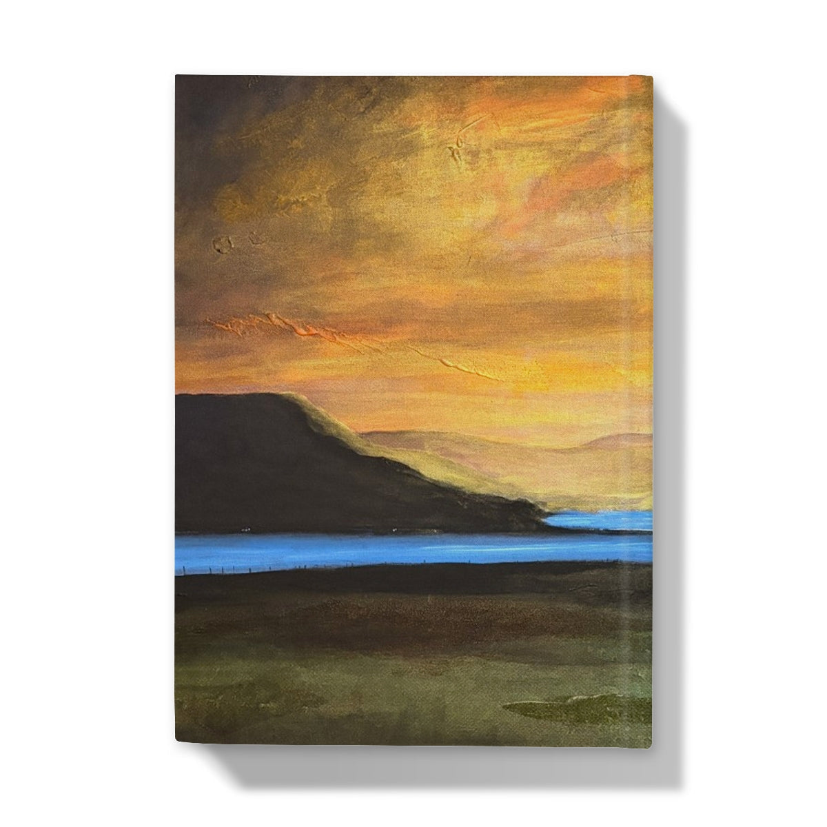 Castle Stalker Glow journal cover: orange sky, silhouetted hills, blue lake