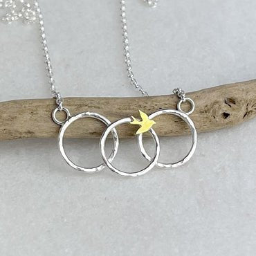 Fly Away Necklace: silver with interlocking rings and yellow bird charm
