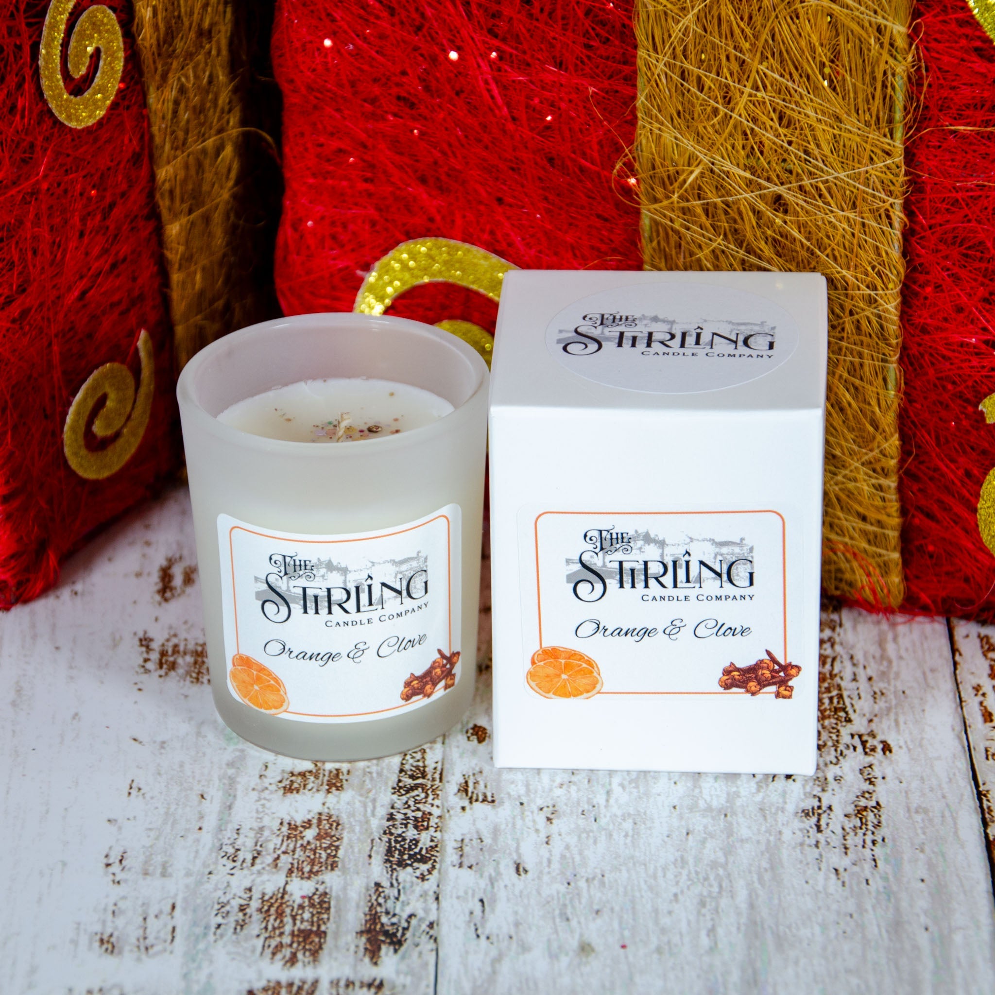A frosted glass orange and clove scented small candle from stirling candle company for home fragrance