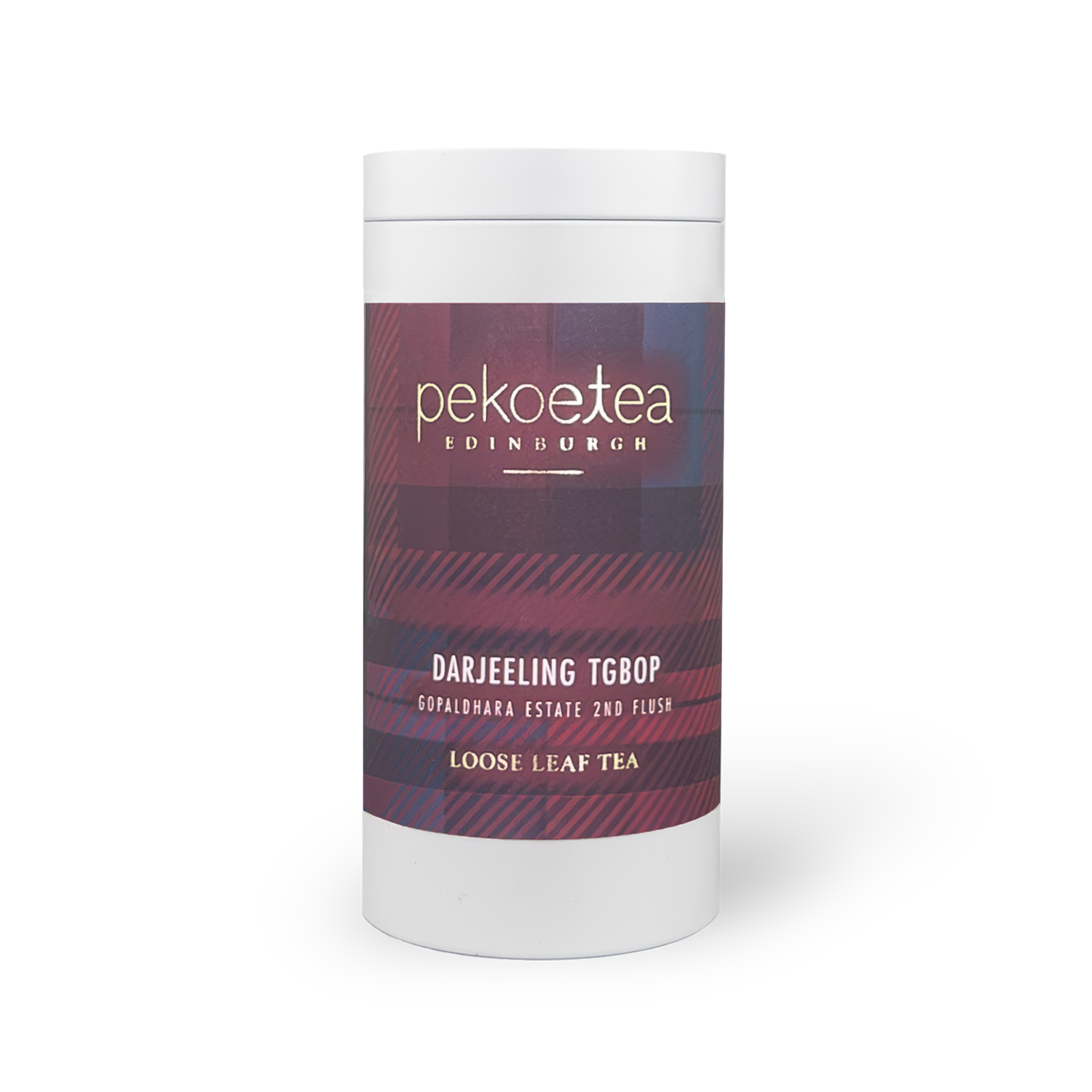 A white cylindrical container of gopaldhara tgbop second flush darjeeling pekoe tea with maroon and navy plaid label