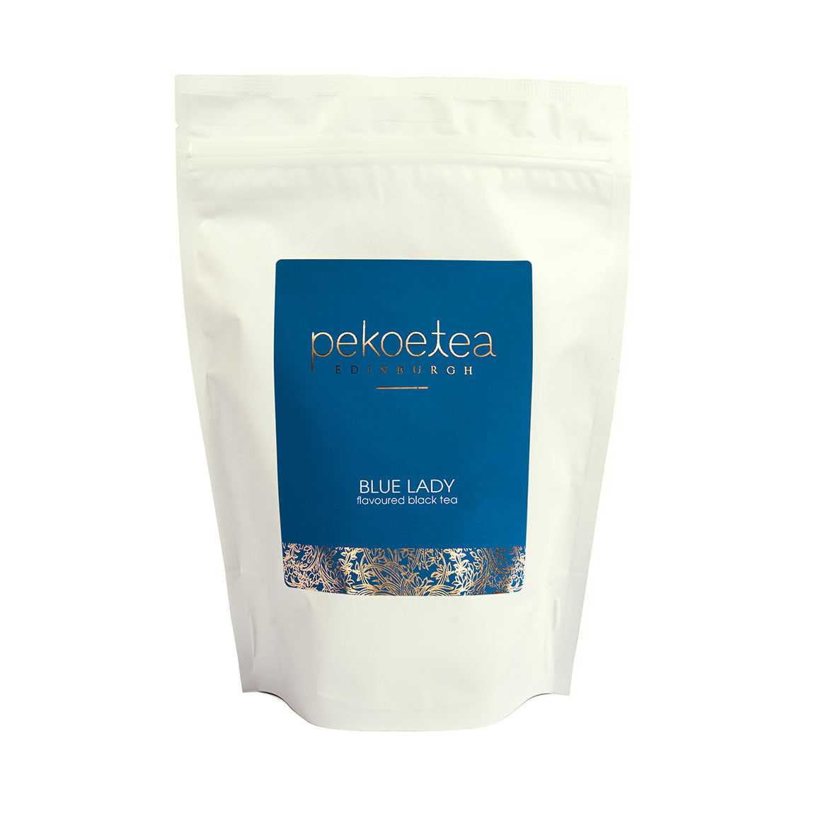 A white resealable pouch of Blue Lady flavored black pekoe tea with a blue label gold lettering and ornate border