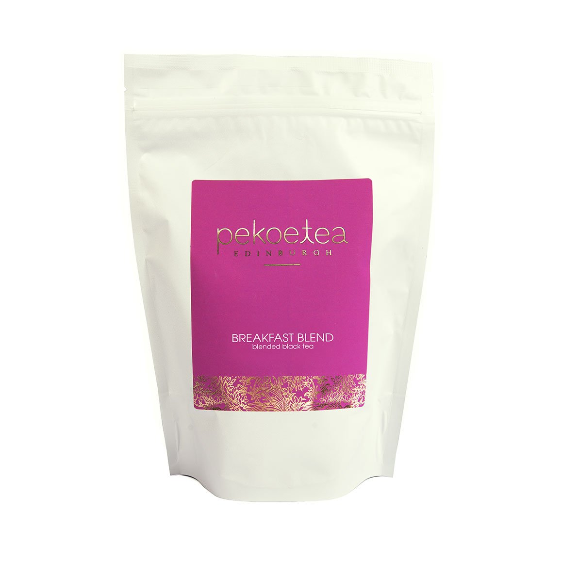 A white resealable pouch of pekoe breakfast blend tea with a vibrant magenta label and gold foil detailing
