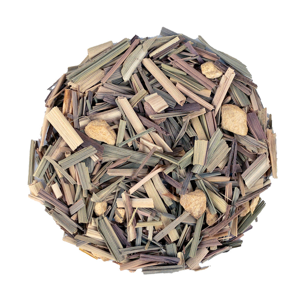 A mound of dried lemongrass and ginger tea with slender greenish-brown stalks and beige chunks