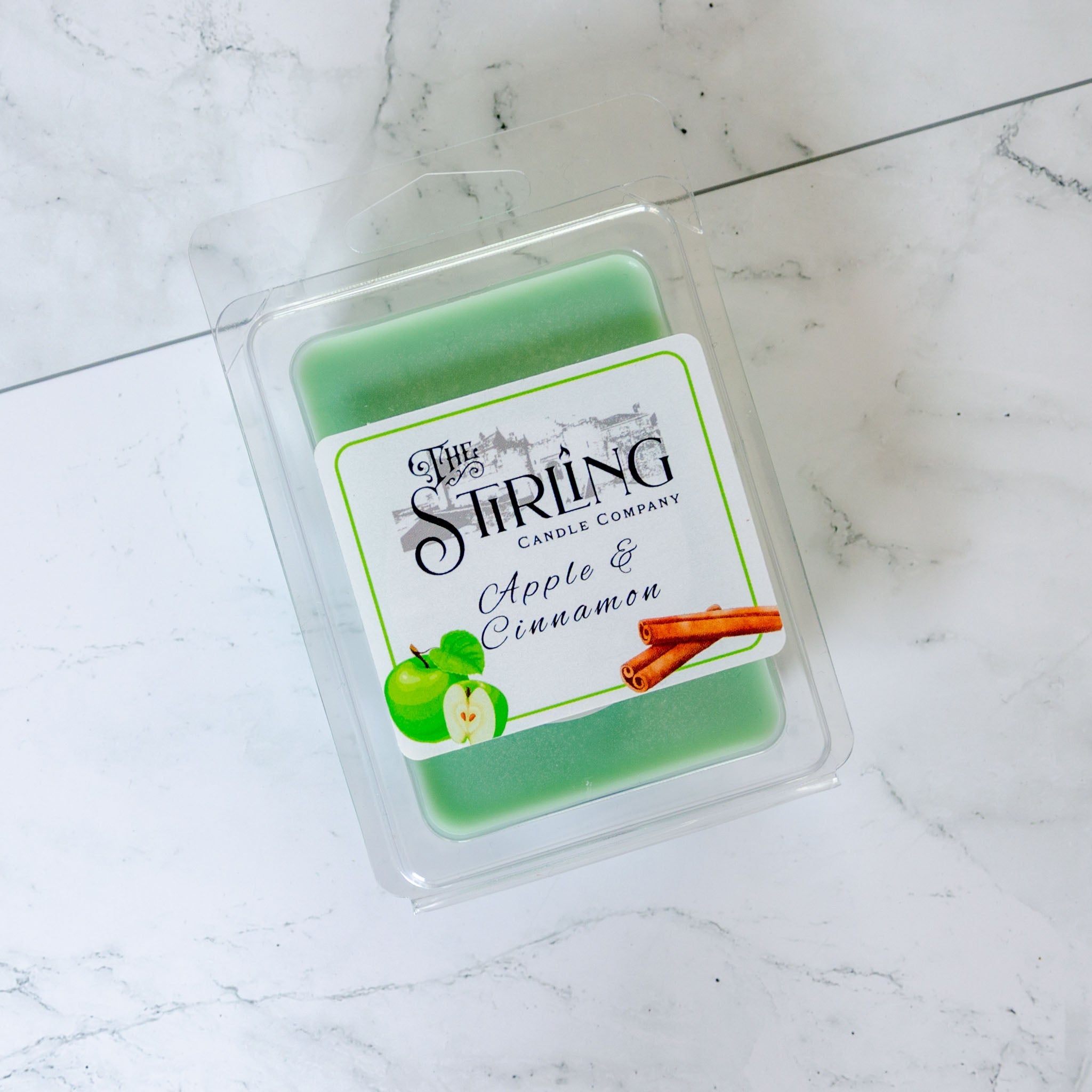 Green apple and cinnamon scented wax melt clamshell in clear plastic container by stirling candle company