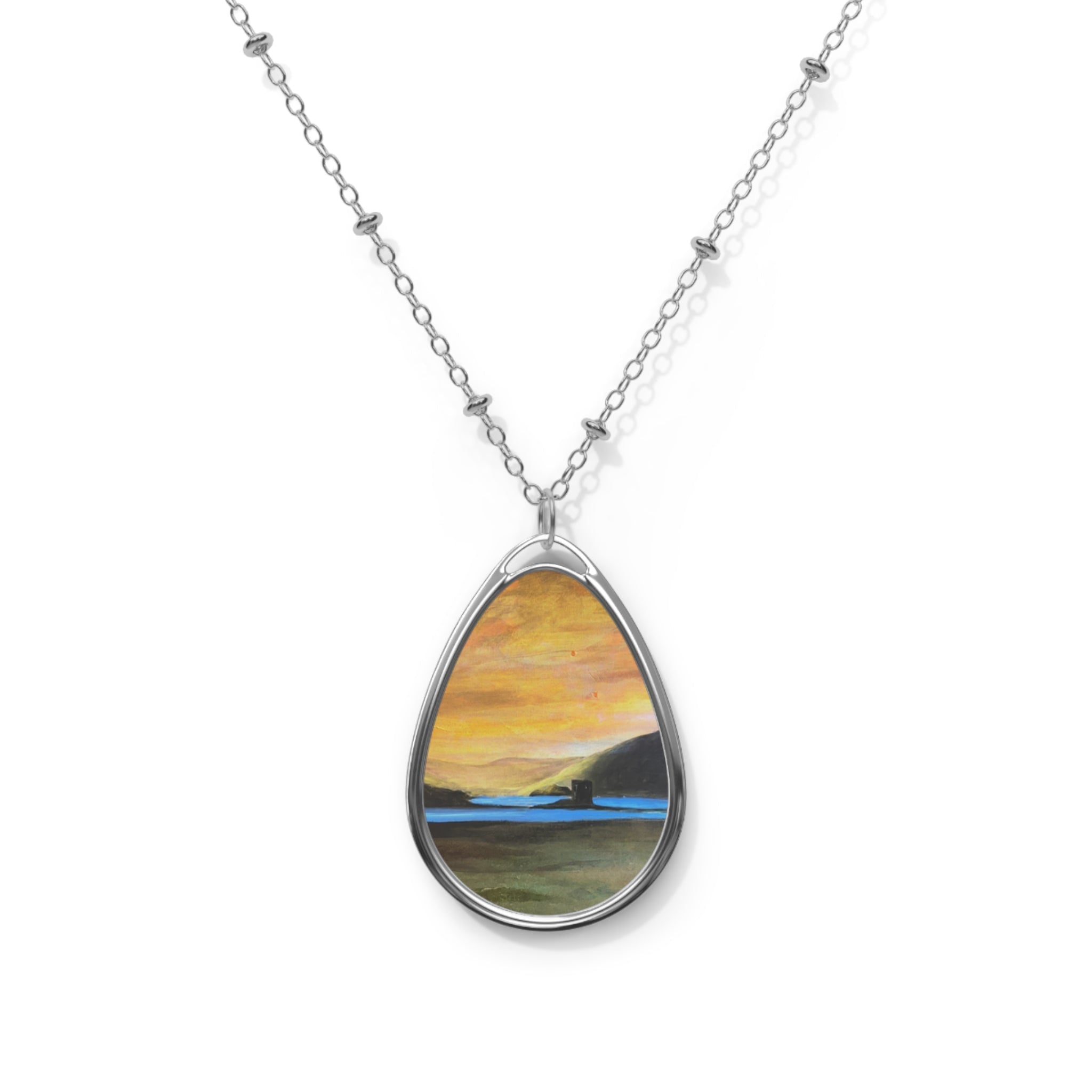 Castle Stalker Glow silver teardrop necklace with miniature sunset scene