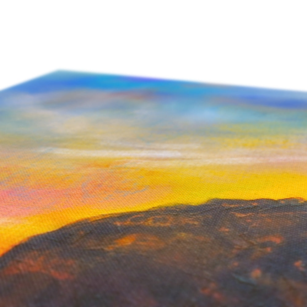 A vibrant sunset over a mountain range featured on the Ailsa Craig Dusk Canvas