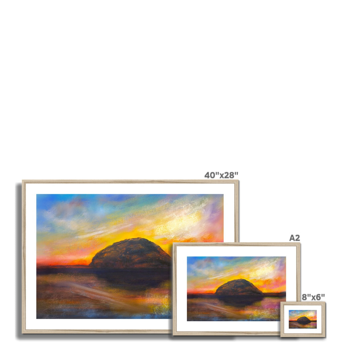 Framed and mounted print of three landscape paintings depicting a sunset over water with a large rock