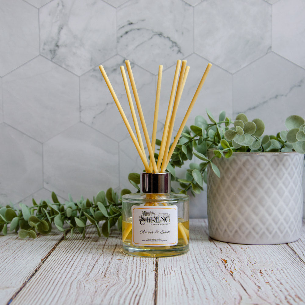 Amber & Spice 100ml diffuser by Stirling Candle Company with yellow liquid and wooden reeds
