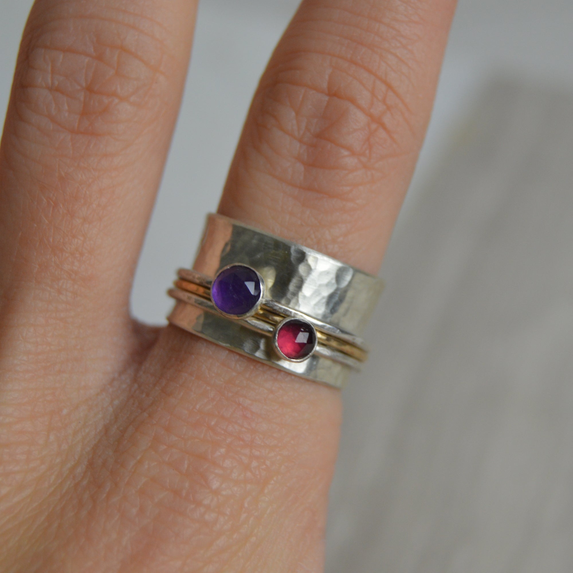 Amethyst and garnet spinning ring with hammered silver and gold bands by Lindsay Mcdowall Jewellery