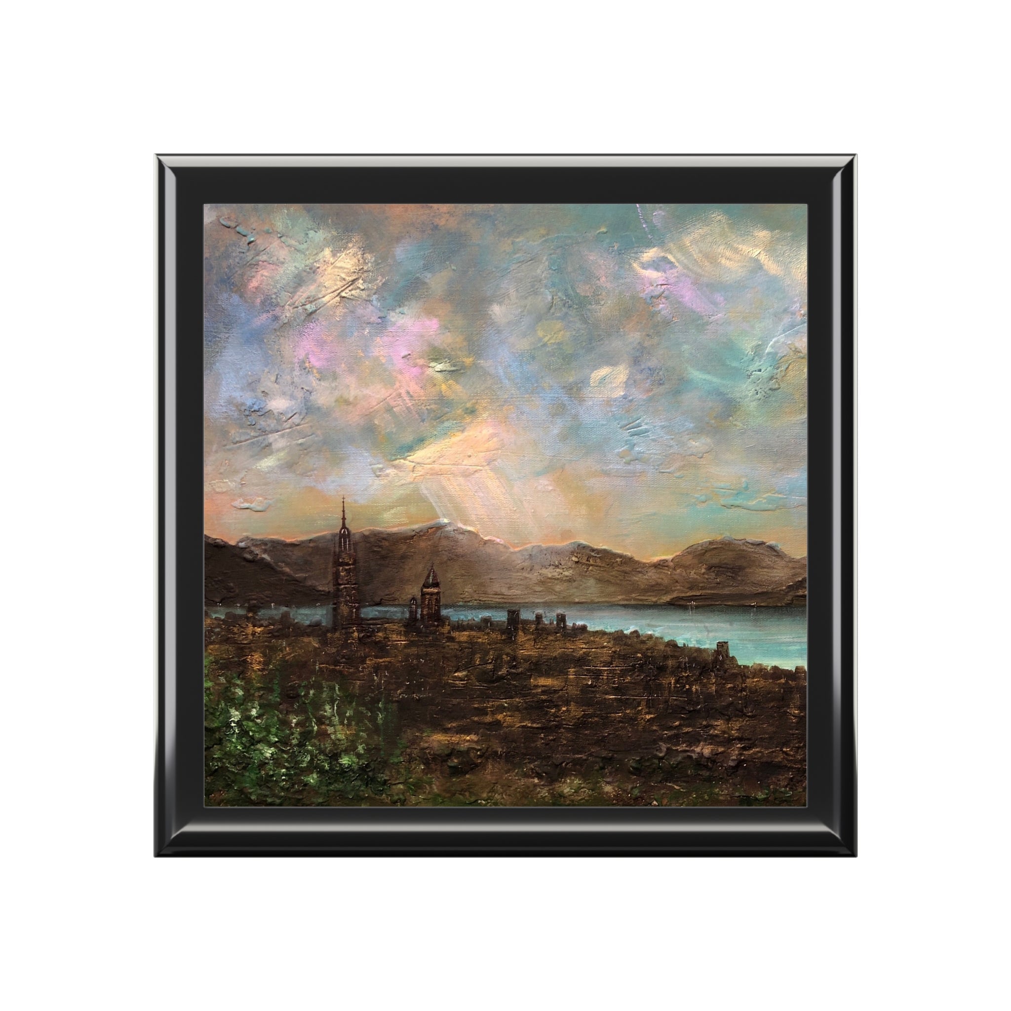 Framed textured oil painting of a city by a lake with mountains and colorful sky