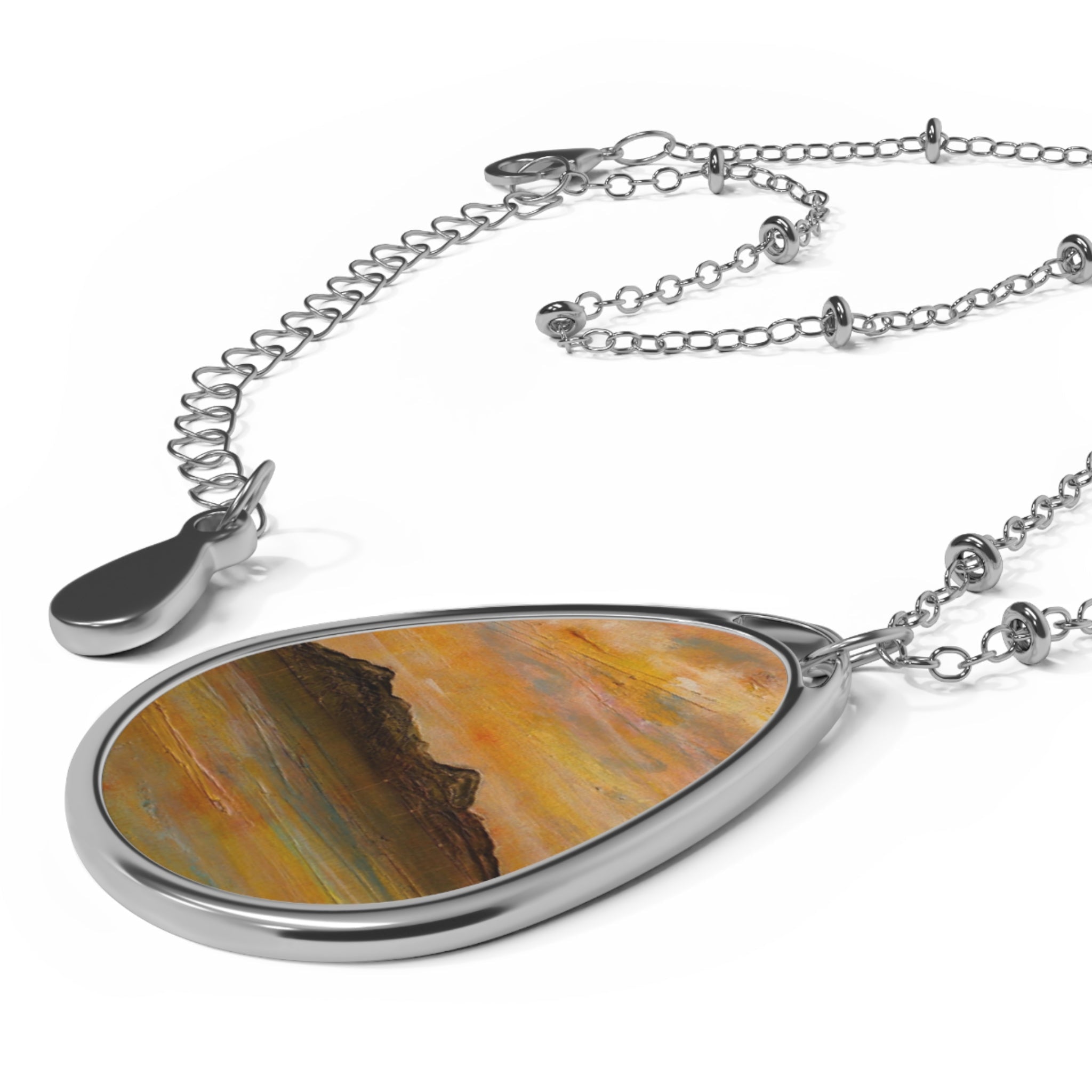 Silver teardrop pendant with abstract Scottish landscape design on a delicate silver chain