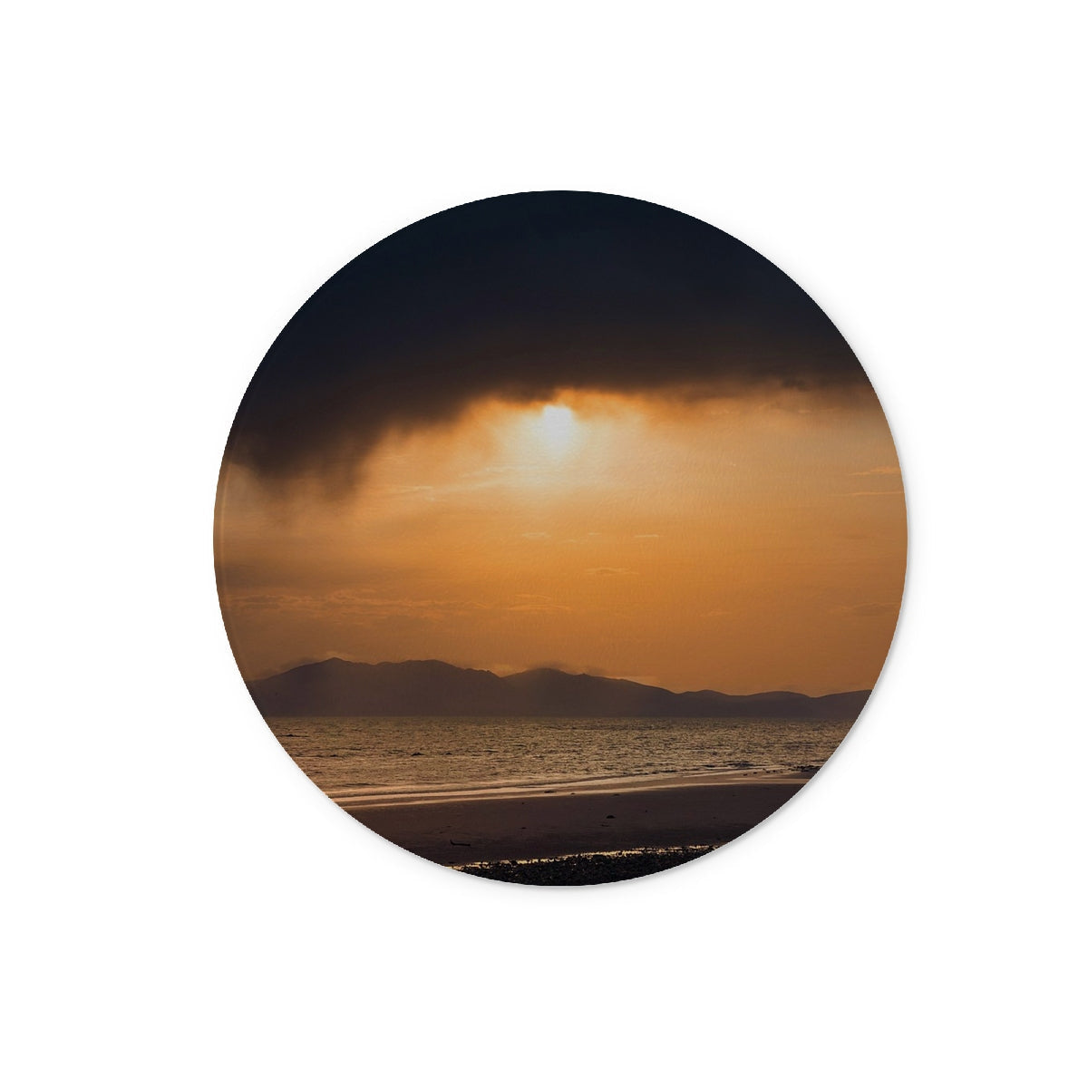 Circular sticker featuring a sunset beach scene on the Arran Stormy Sunset Glass Chopping Board