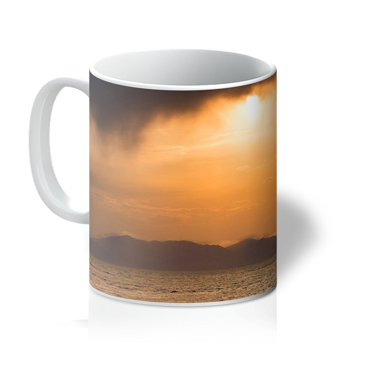 White ceramic Arran Stormy Sunset Mug with an orange sunset scene illustration