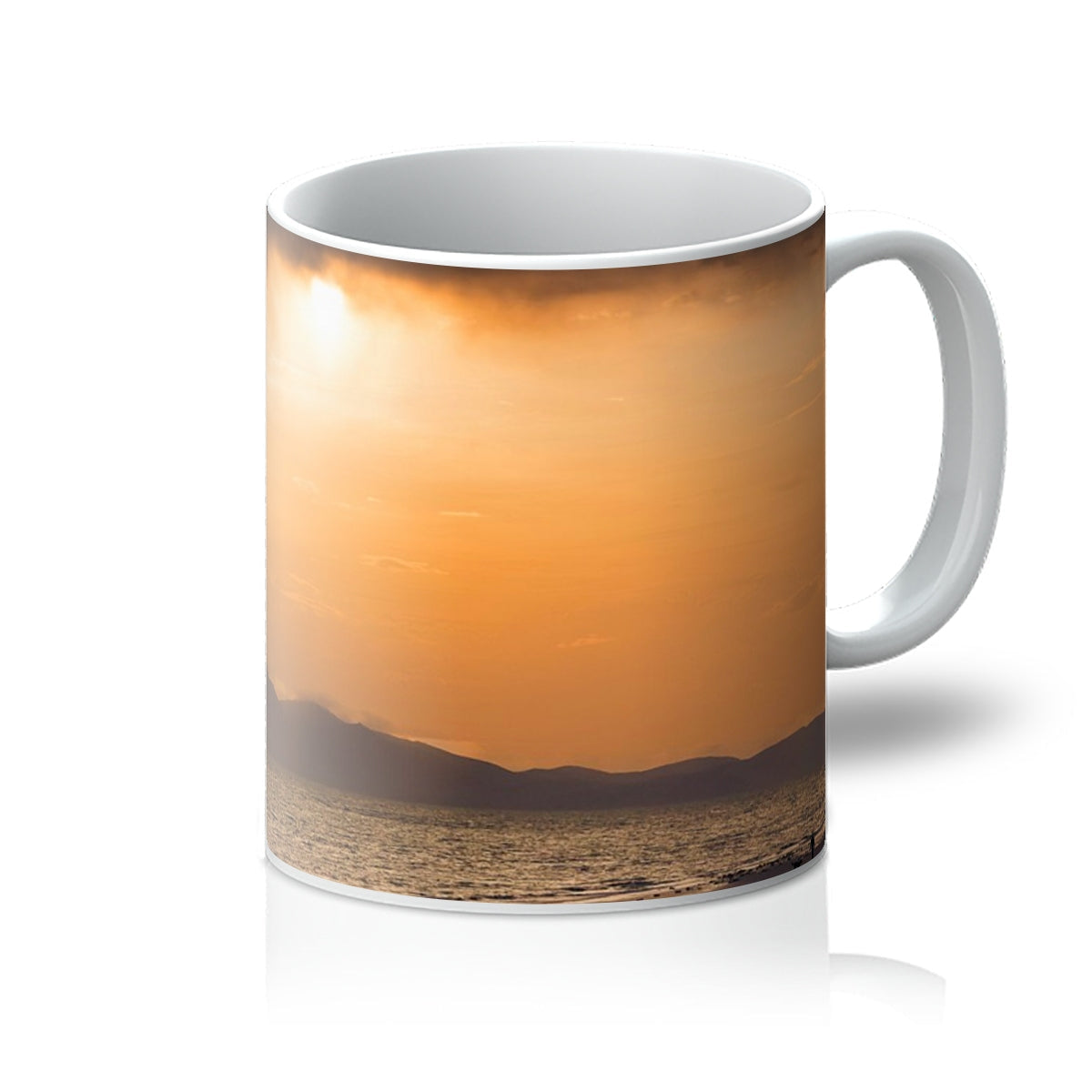 White ceramic Arran Stormy Sunset Mug featuring an orange sunset over water and mountains