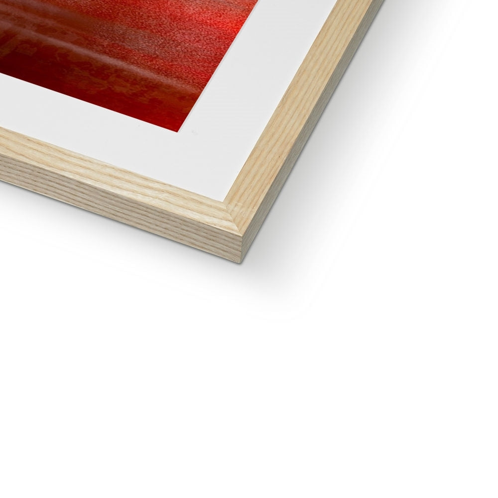 Light wood-framed Arran Sunset print with white mat and vibrant red abstract artwork