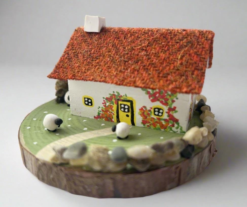 Miniature Scottish Bothy figurine with textured orange roof, painted vines, flowers, sheep, and stone fence