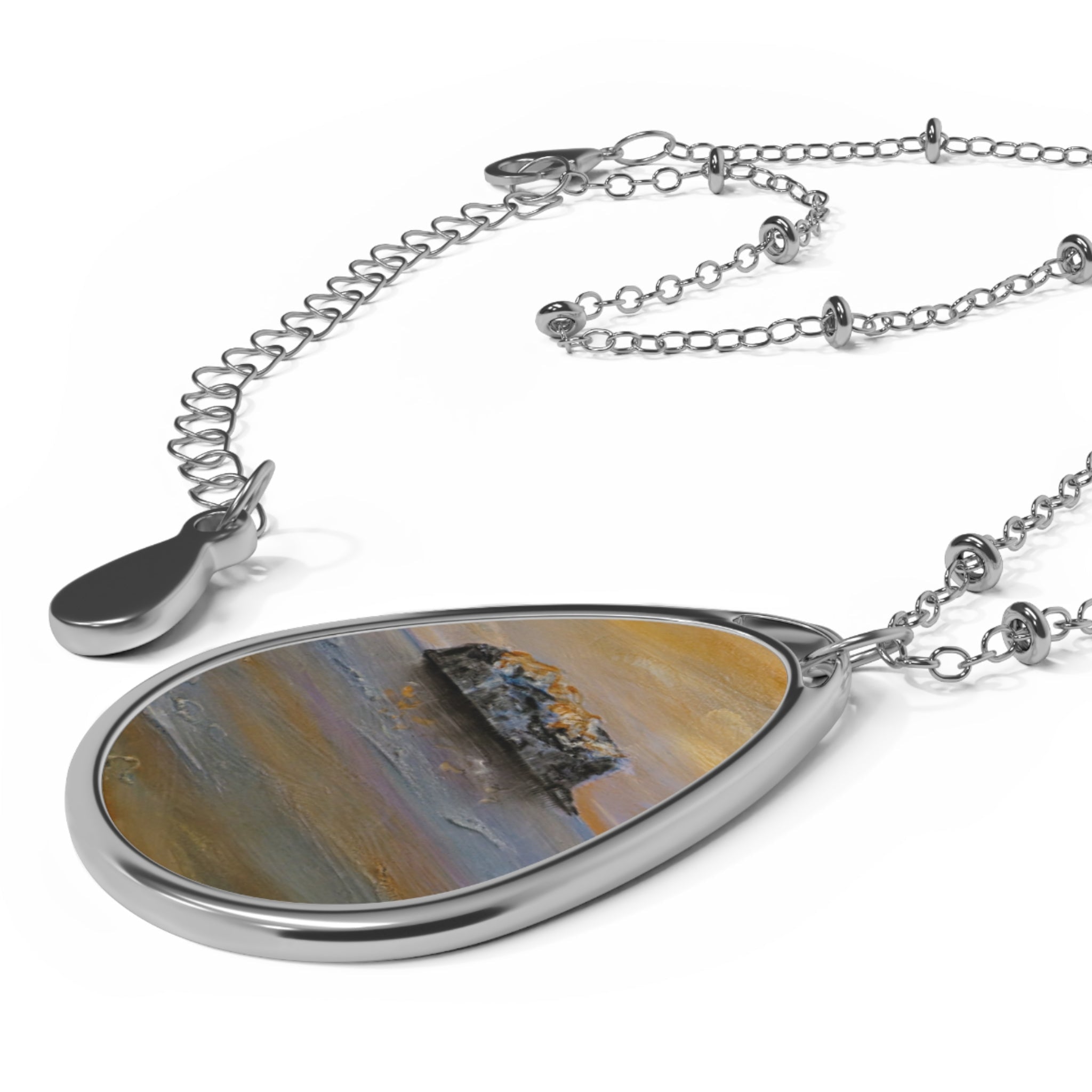 Silver-toned chain necklace with oval pendant featuring abstract Scottish art design