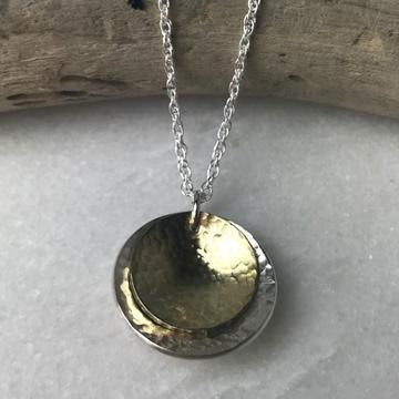 Brass coin necklace with silver chain and double-layered gold and silver pendant by Lindsay Mcdowall Jewellery