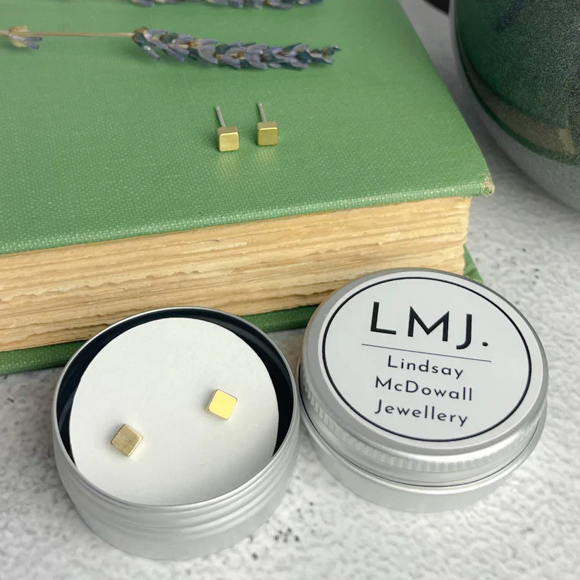 Gold brass cube stud earrings displayed in a silver tin from lindsay mcdowall jewellery