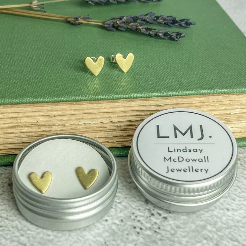 Gold heart-shaped brass stud earrings in silver tin by Lindsay Mcdowall Jewellery