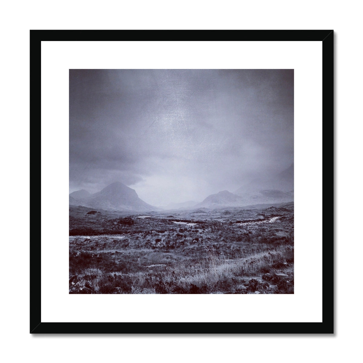 Black-framed Brooding Cuillin print with misty mountains and grassland