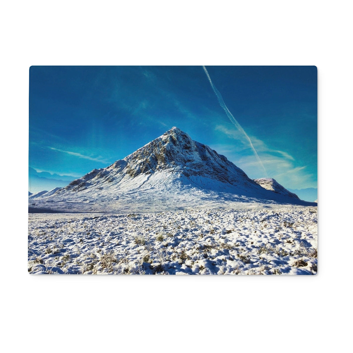 Snowy Buachaille Etive Mor peak under blue sky on glass chopping board