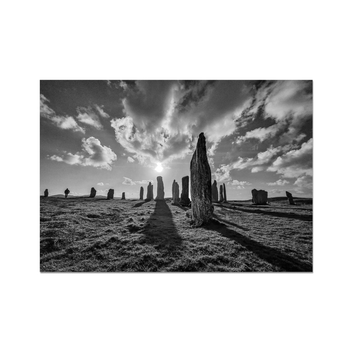 Black-and-white photo of Calanais standing stones on Isle of Lewis under dramatic sky