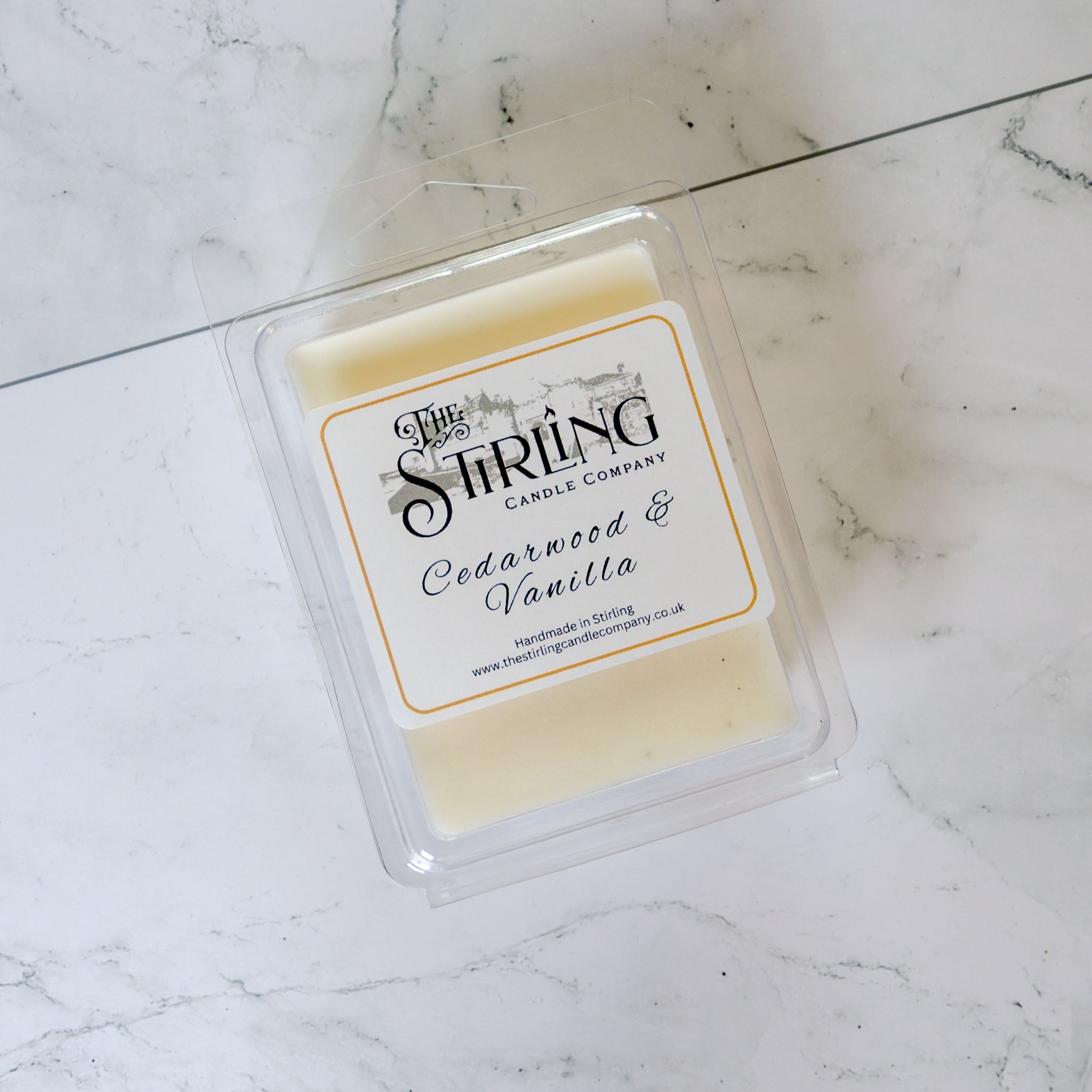 Pale yellow Cedarwood & Vanilla wax melt clamshell by Stirling Candle Company