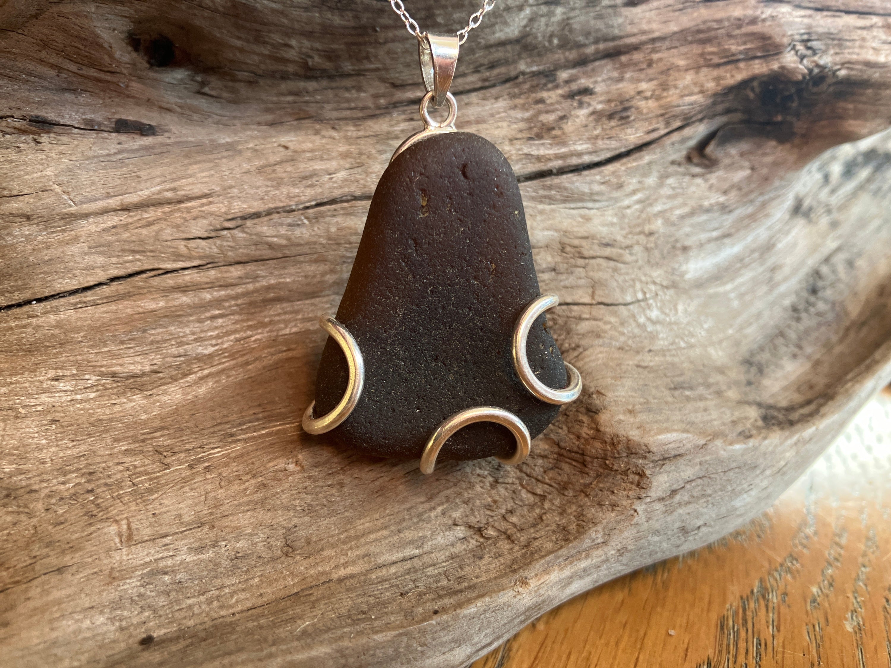 Dark teardrop-shaped Scottish Seaglass pendant with silver wire accents for the Chocolate Bubbles 925 collection