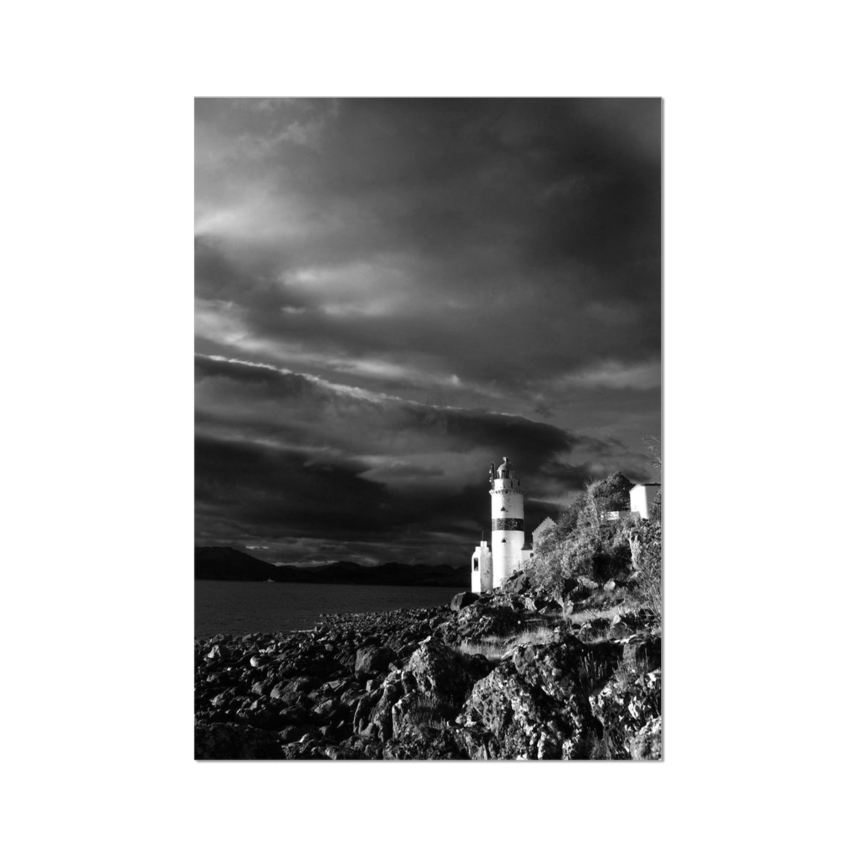 Black-and-white photo of Cloch Lighthouse on stormy coastal rocks