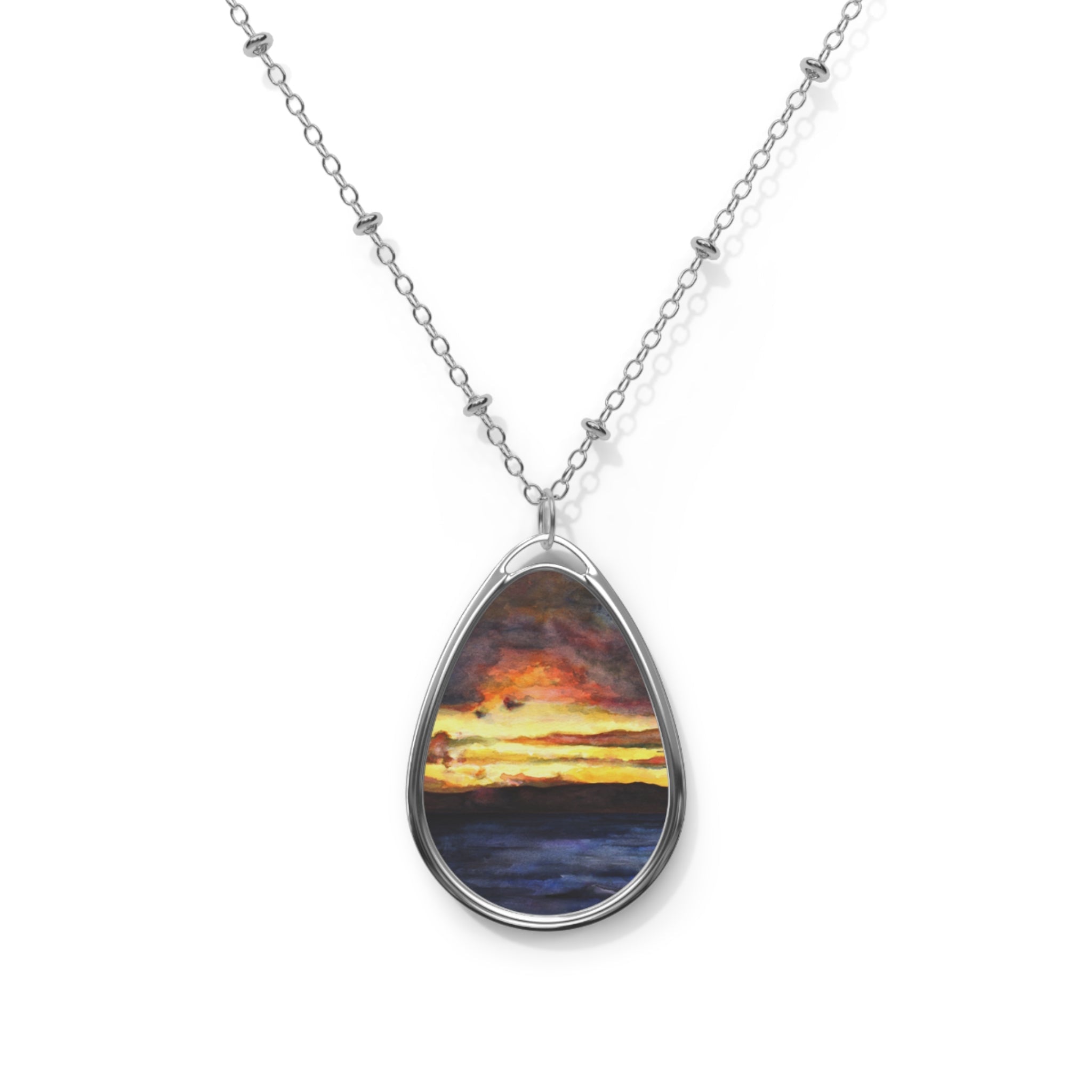 Silver chain necklace with oval pendant depicting a sunset over water from Clyde Sunset collection