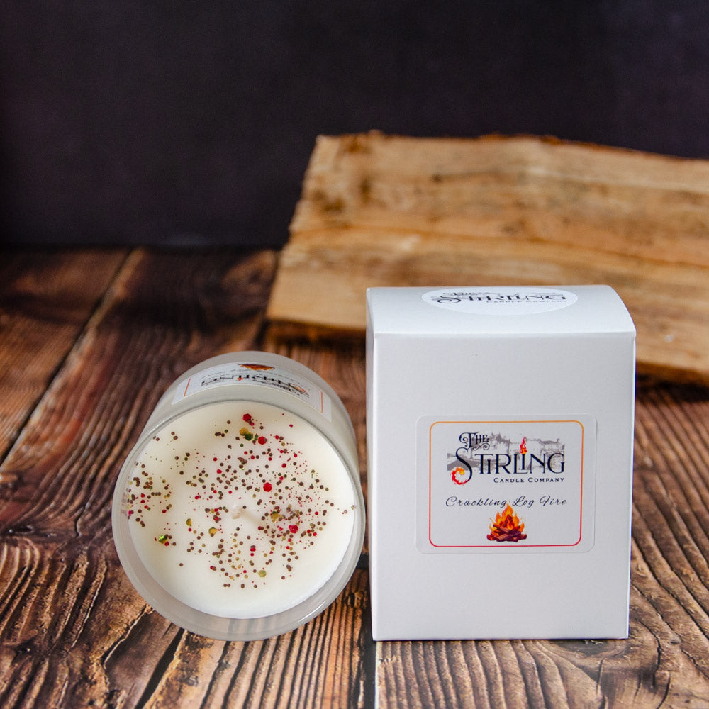 Crackling Log Fire medium white scented candle in clear glass jar with glittery flecks