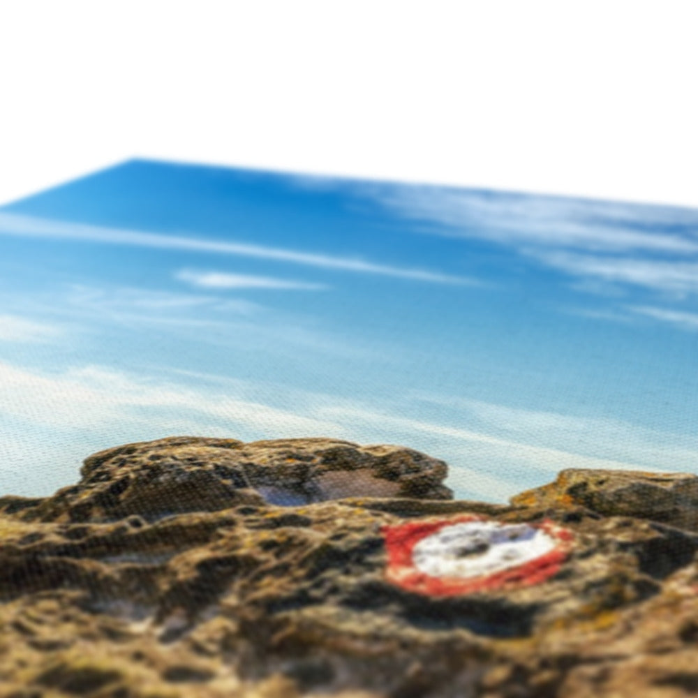 Red and white circular sticker on Crocodile Rock Millport canvas print