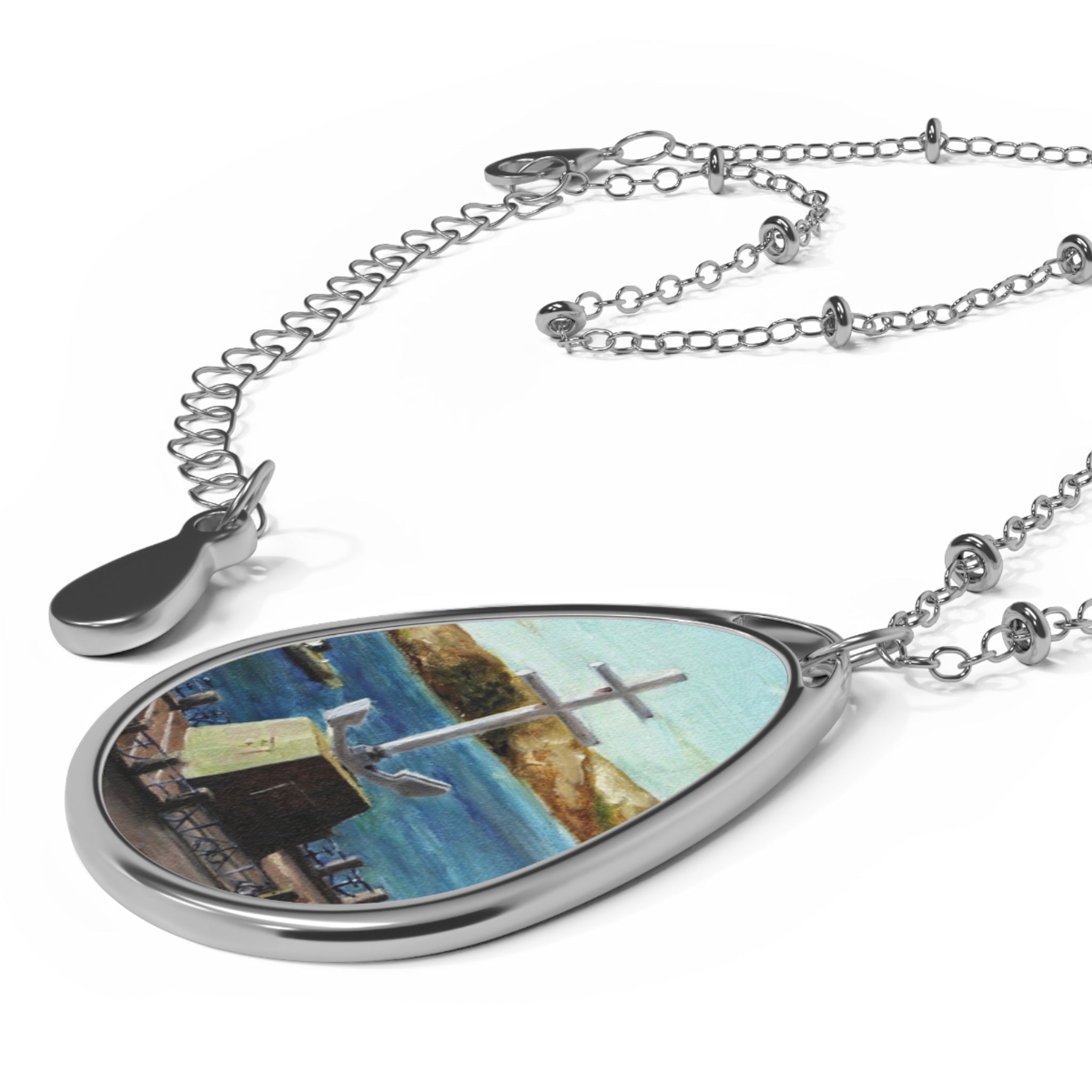 Silver-toned teardrop pendant necklace with colorful Scottish landscape art