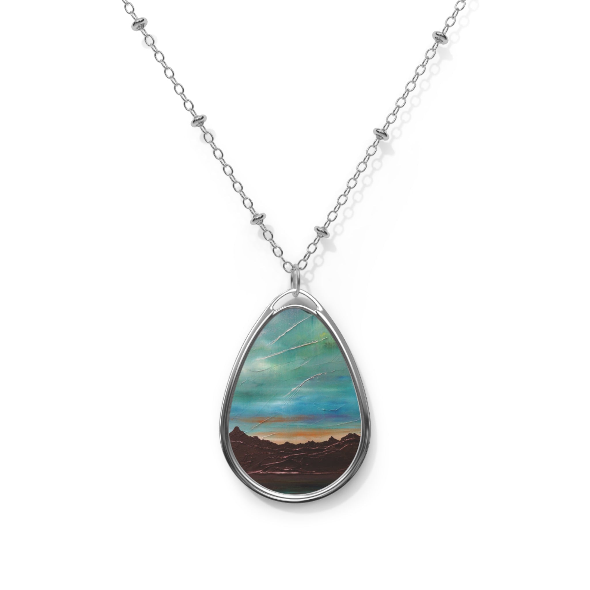 Silver chain necklace with teardrop pendant featuring a painted landscape of Skye