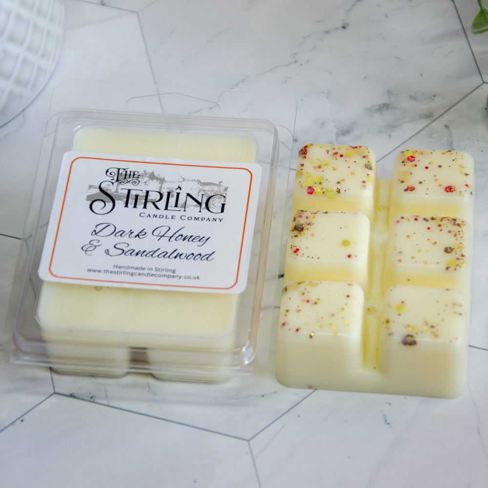 Dark Honey & Sandalwood wax melts in clear tray with red brown flecks
