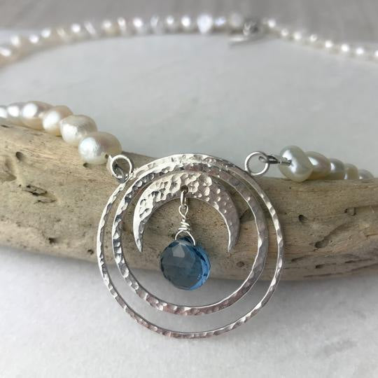 Blue topaz crescent moon necklace with silver pendant and white pearls
