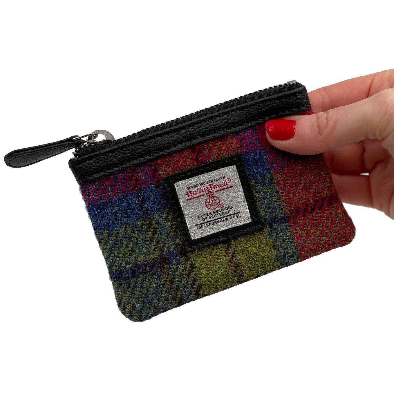 A colorful plaid harris tweed coin purse in blue and pink check with black zipper and leather pull