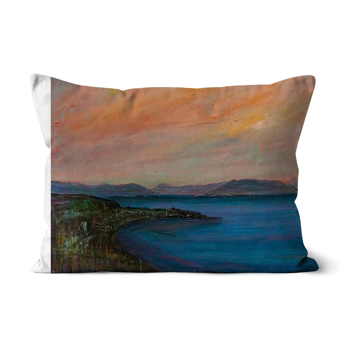 Decorative pillow with painted coastal scene featuring blue sea, shoreline, mountains, and warm sky