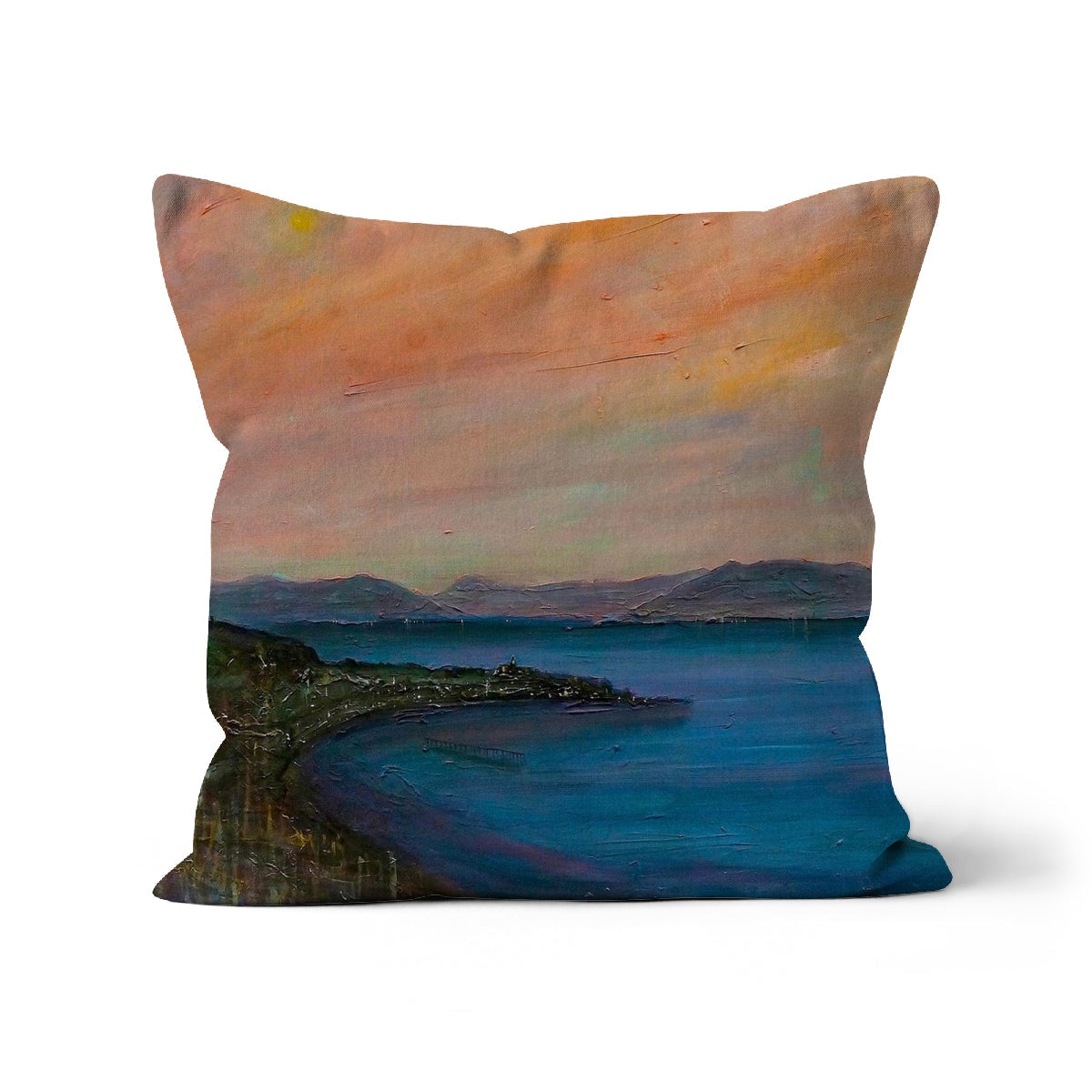 Decorative throw pillow with painted landscape of water, mountains, and colorful sky