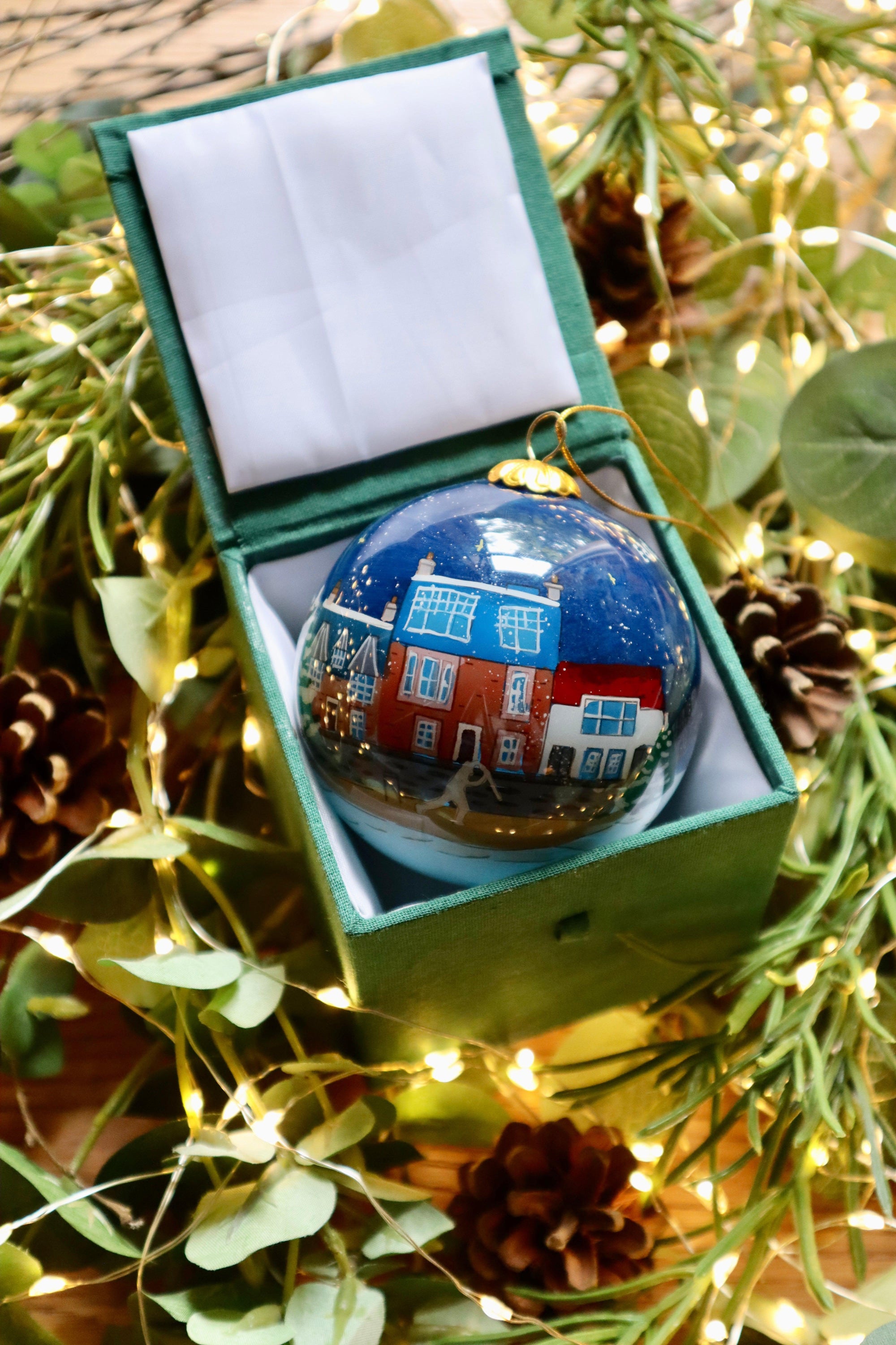 East Neuk of Fife Scottish Christmas bauble in glossy blue glass with snowy houses