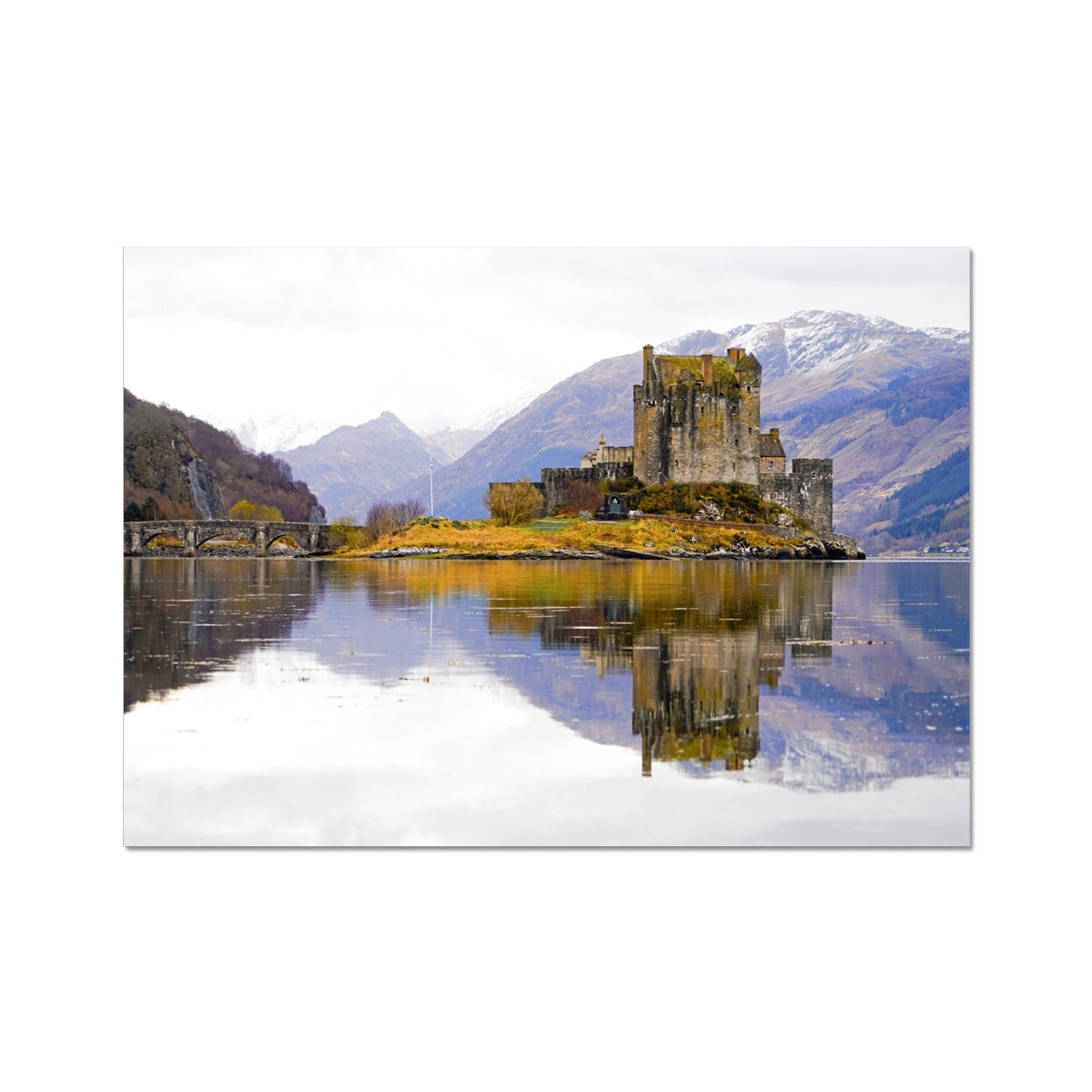 Eilean Donan Castle print with mossy stone walls, reflective water, and snow-capped mountains