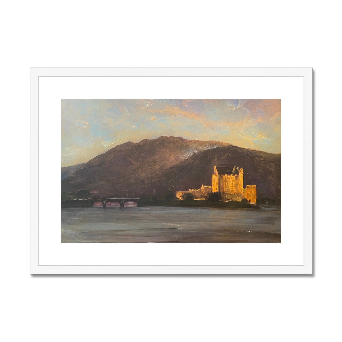 Framed landscape print of Eilean Donan Castle by a lake at sunset