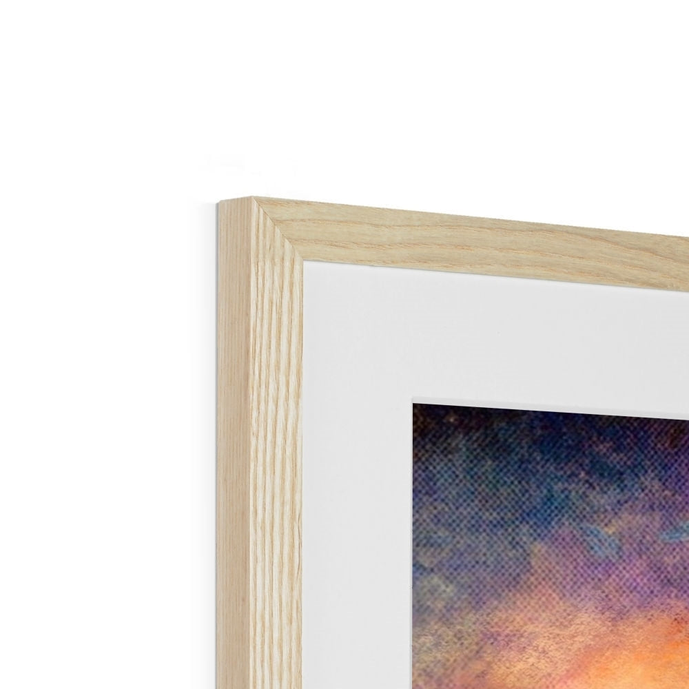 Light wood picture frame with white mat showcasing colorful artwork of Eilean Donan Castle at moonlight